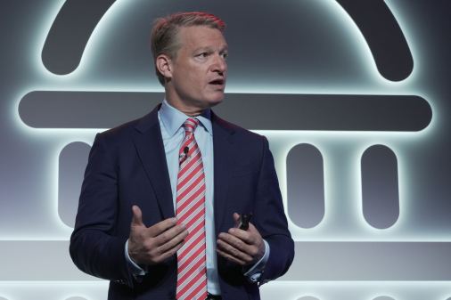 The cybersecurity executive Kevin Mandia speaks against a backdrop depicting a stylized version of the U.S. Capitol.