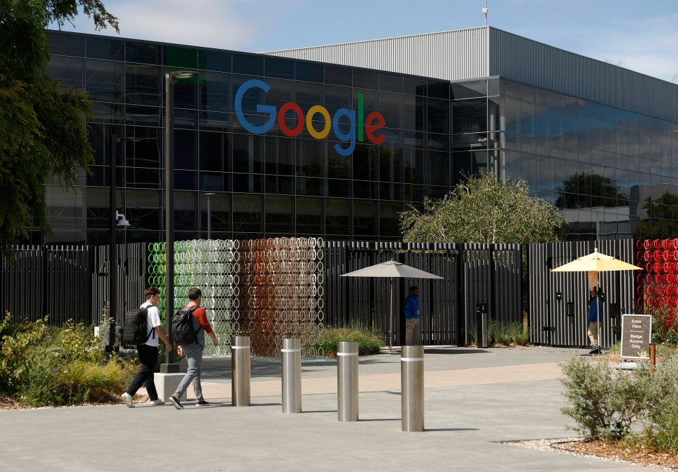 Workers enter a building on the Google headquarters campus on July 23, 2025, in Mountain View, California.