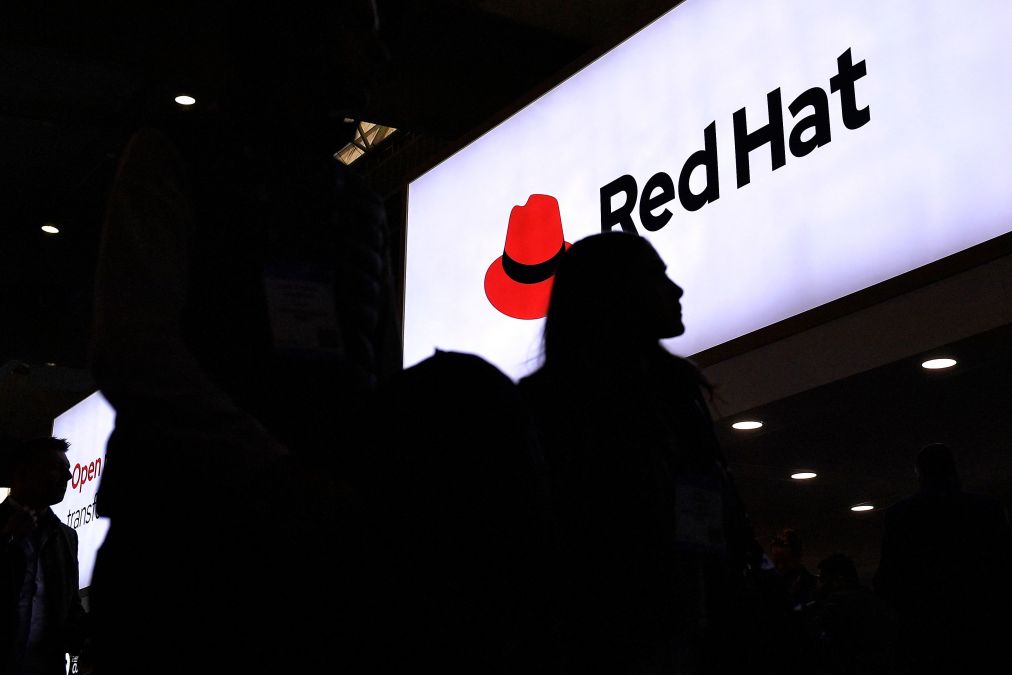 A visitor walks past Red Hat logo at the MWC in Barcelona on Feb. 27, 2023. (Pau Barrena/Getty Images)